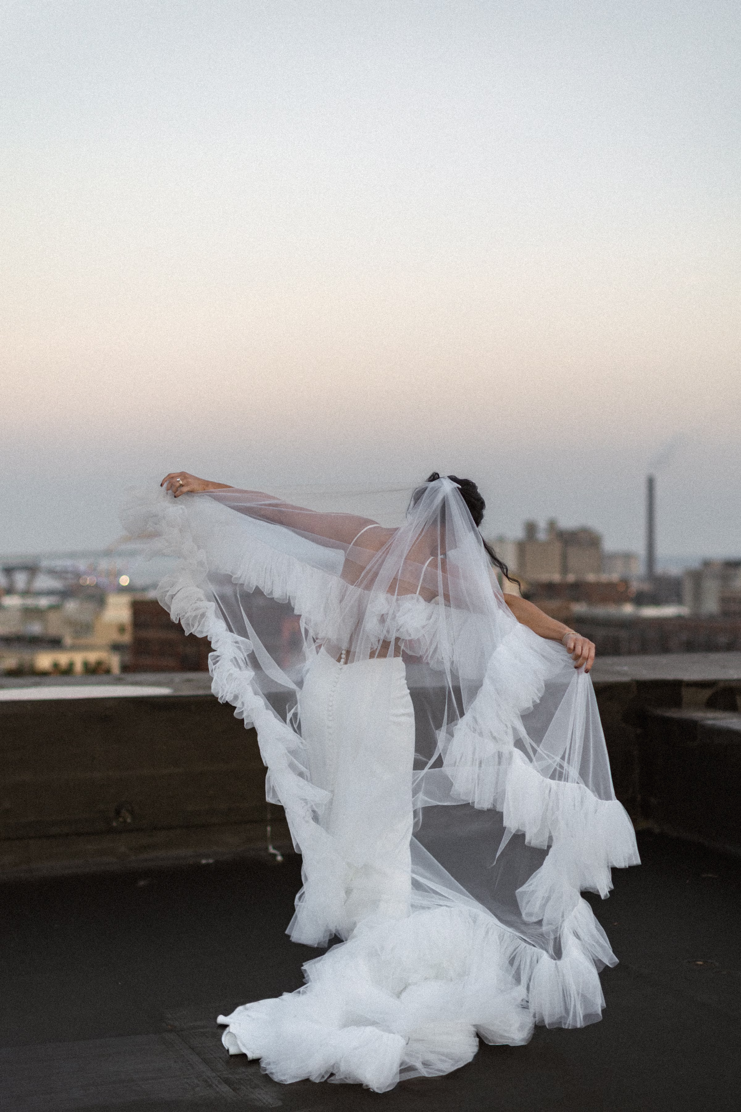 a bride shows off her statement veil, a tiered, tulle, statement piece