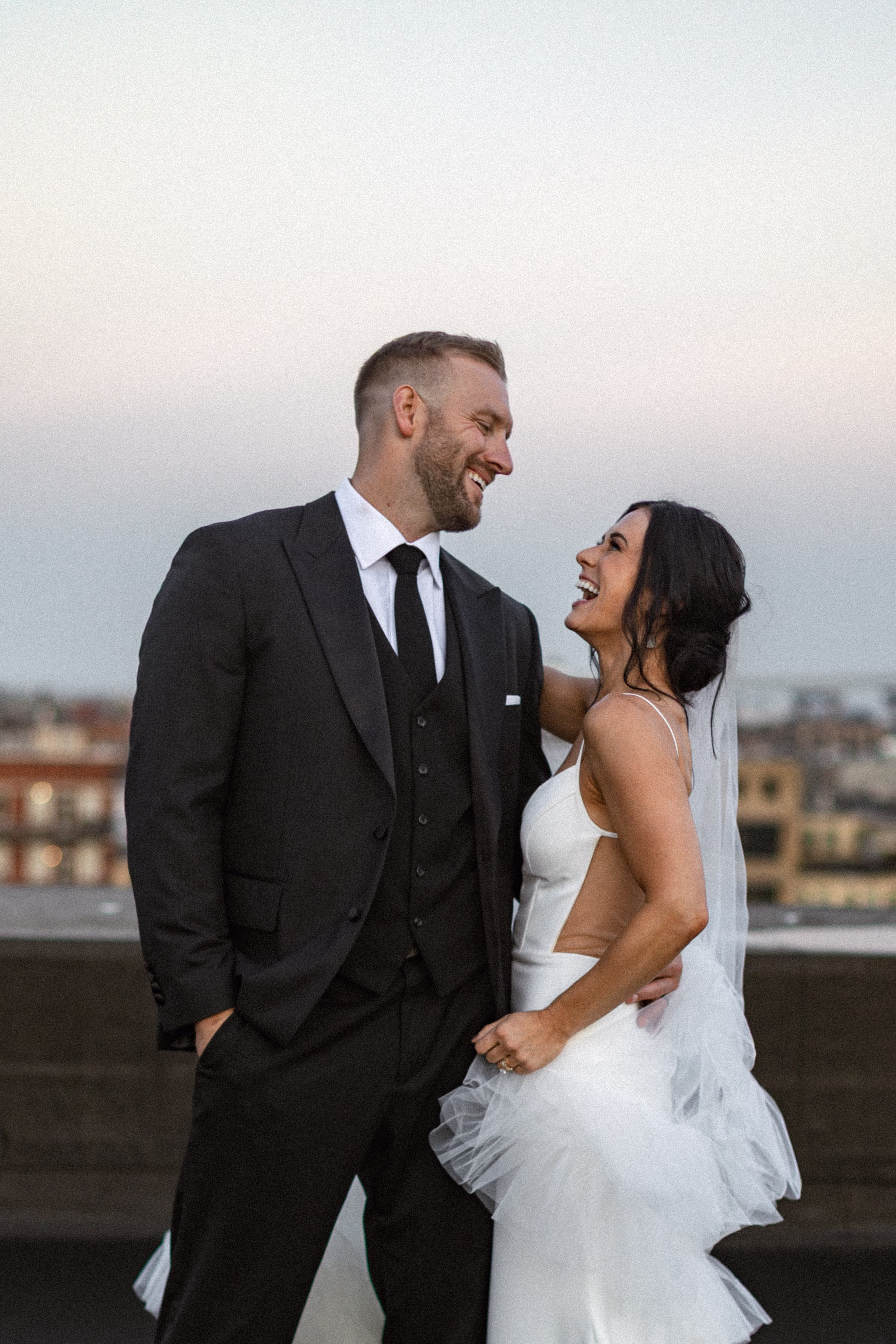 the newlywed couple looks at each other, smiling