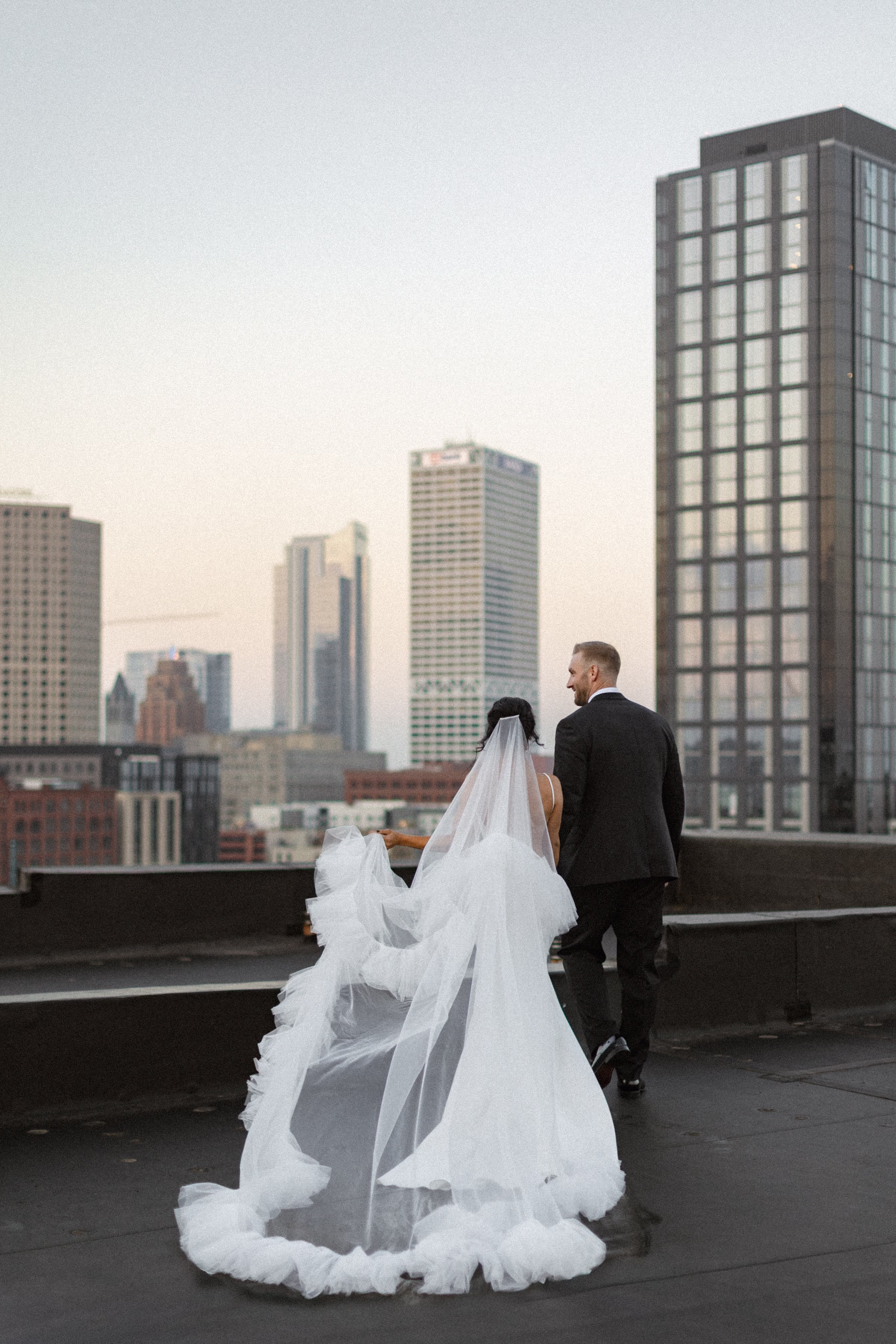 rooftop photos of the couple featuring a statement tiered-tulle veil