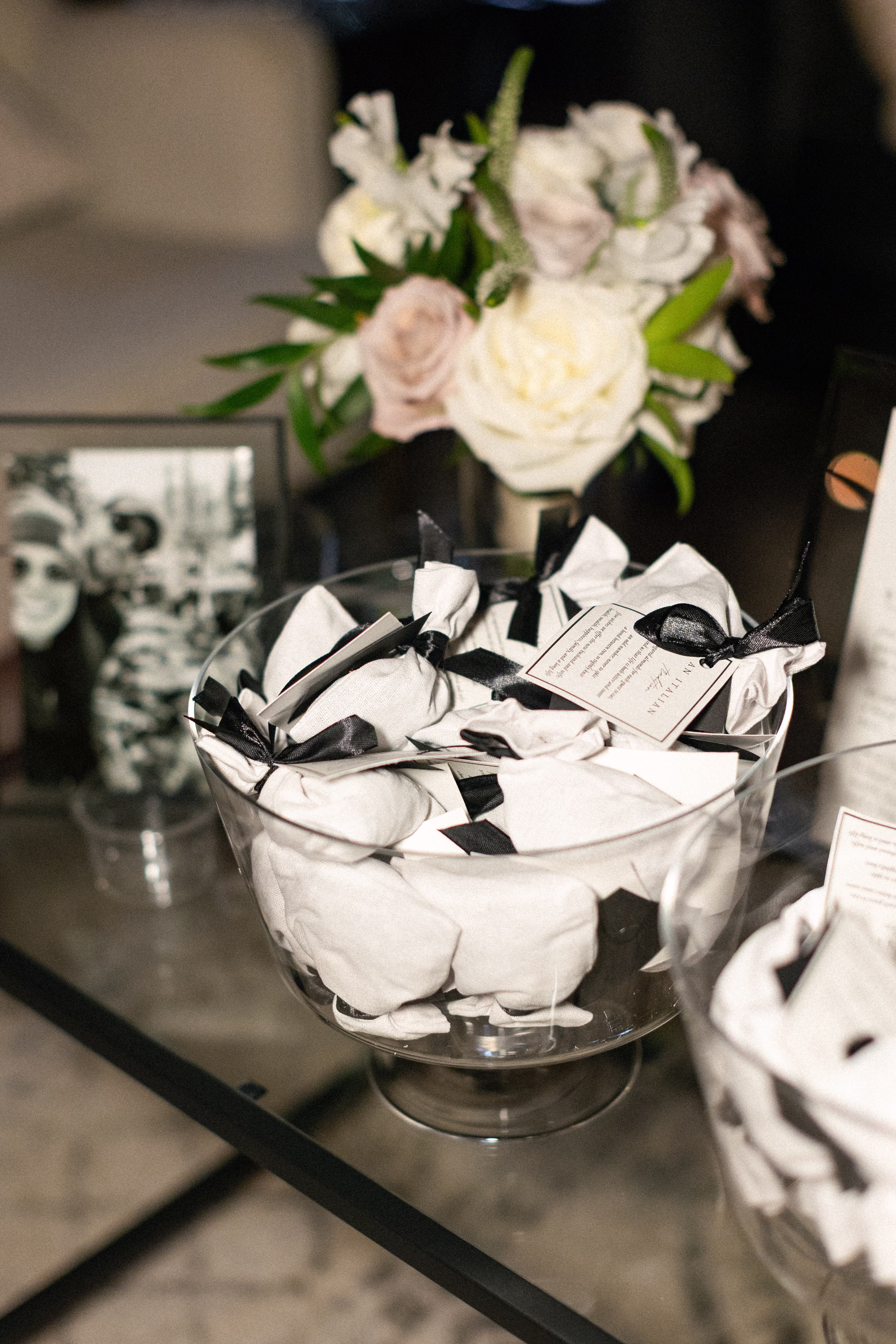 guest favors in bags, tied with black ribbons, and featuring a printed tag