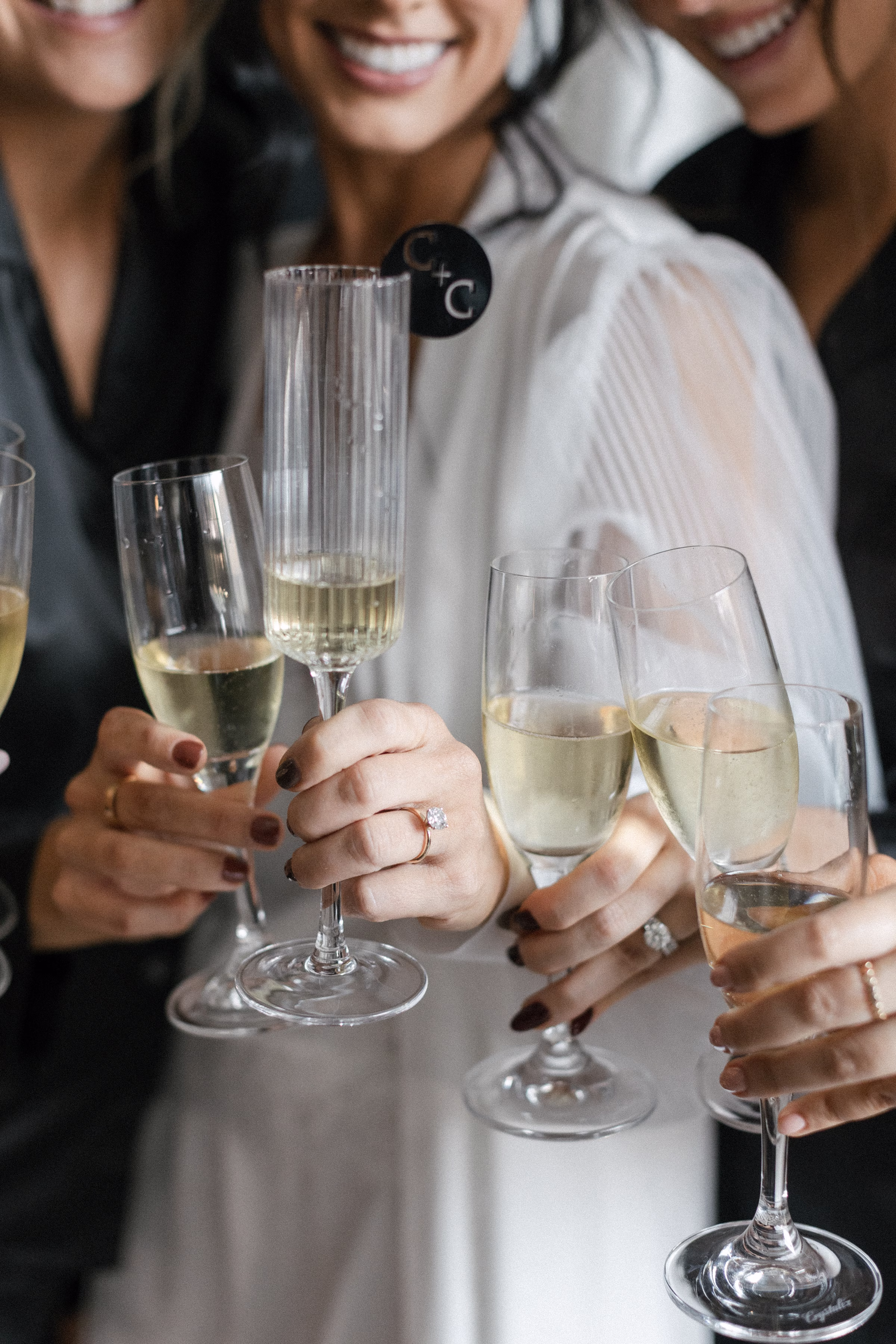 the bride and bridesmaids toast champagne glasses