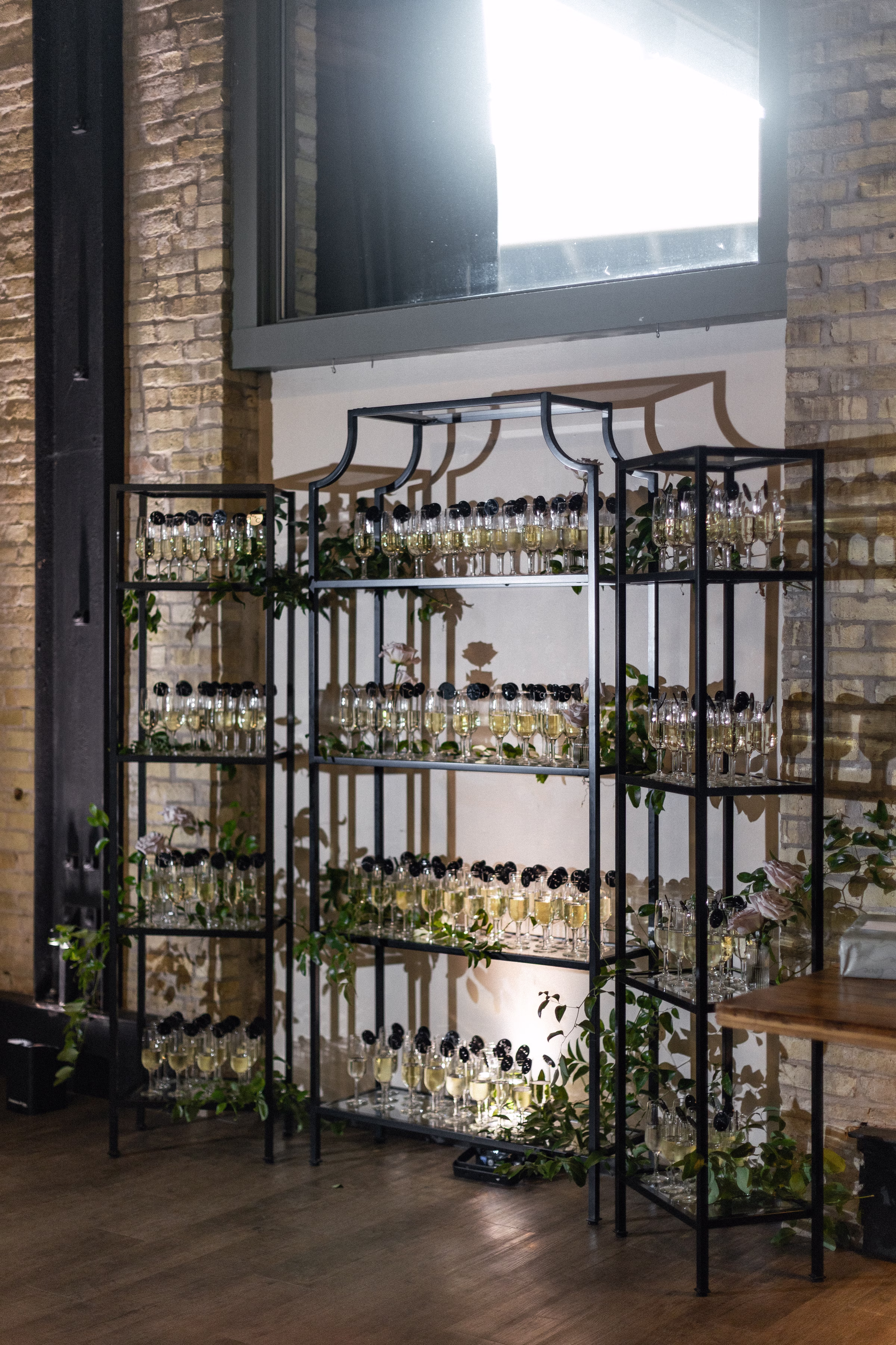 a champange wall, with the couple monogram on each glass