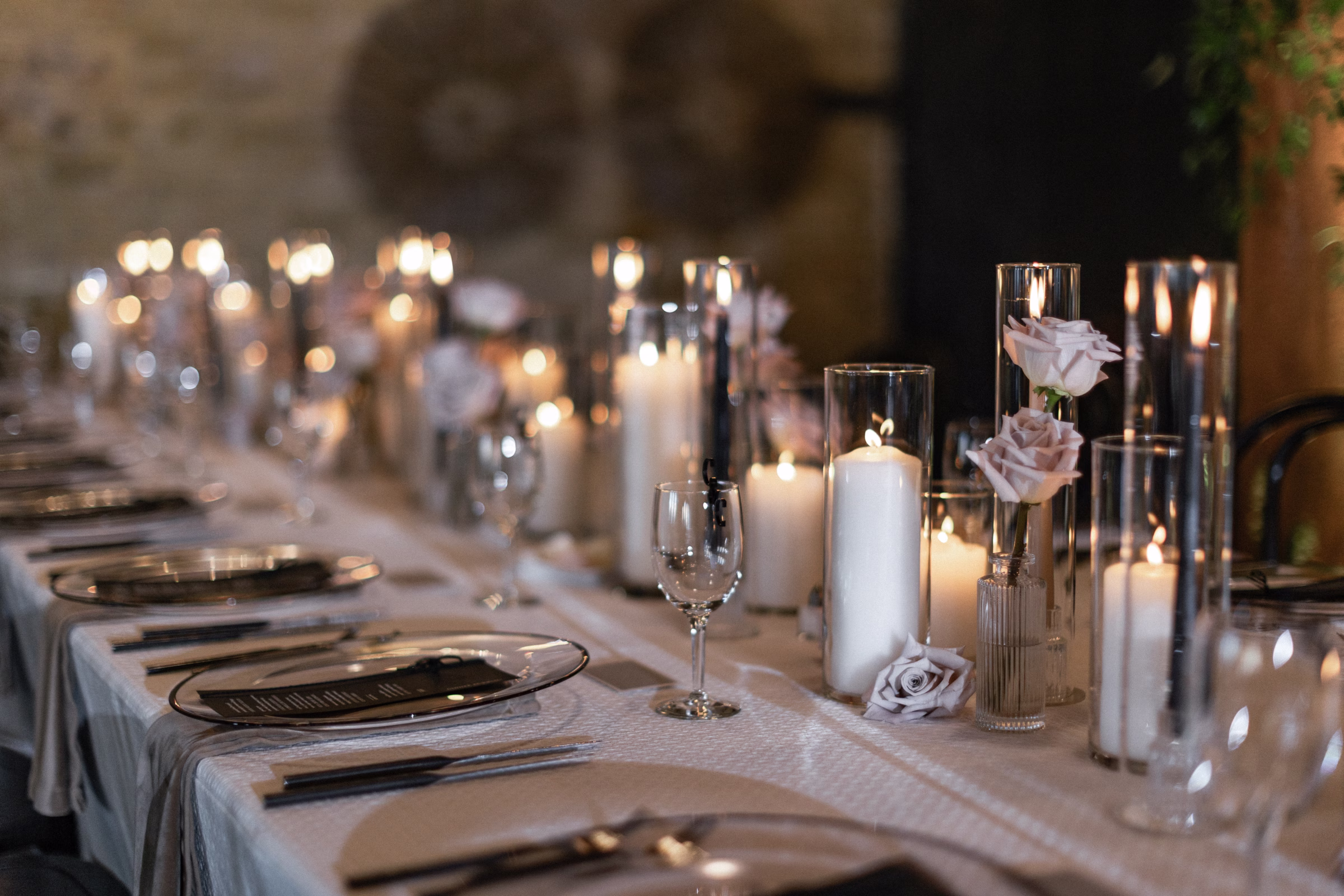 table setting and centerpieces, highlighting a candlelit atmosphere