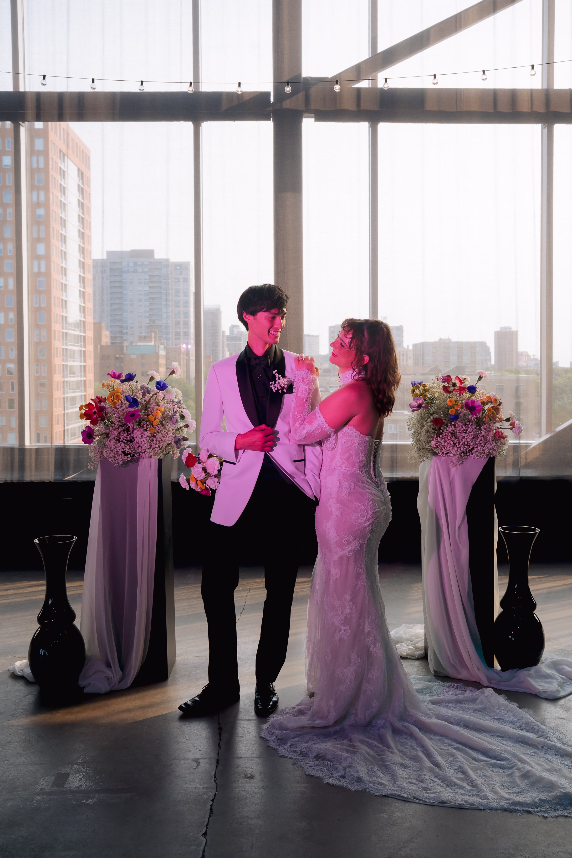 the bride and groom models smile at each other at a colorful wedding inspiration at Jan Serr Studio in Milwaukee, Wisconsin