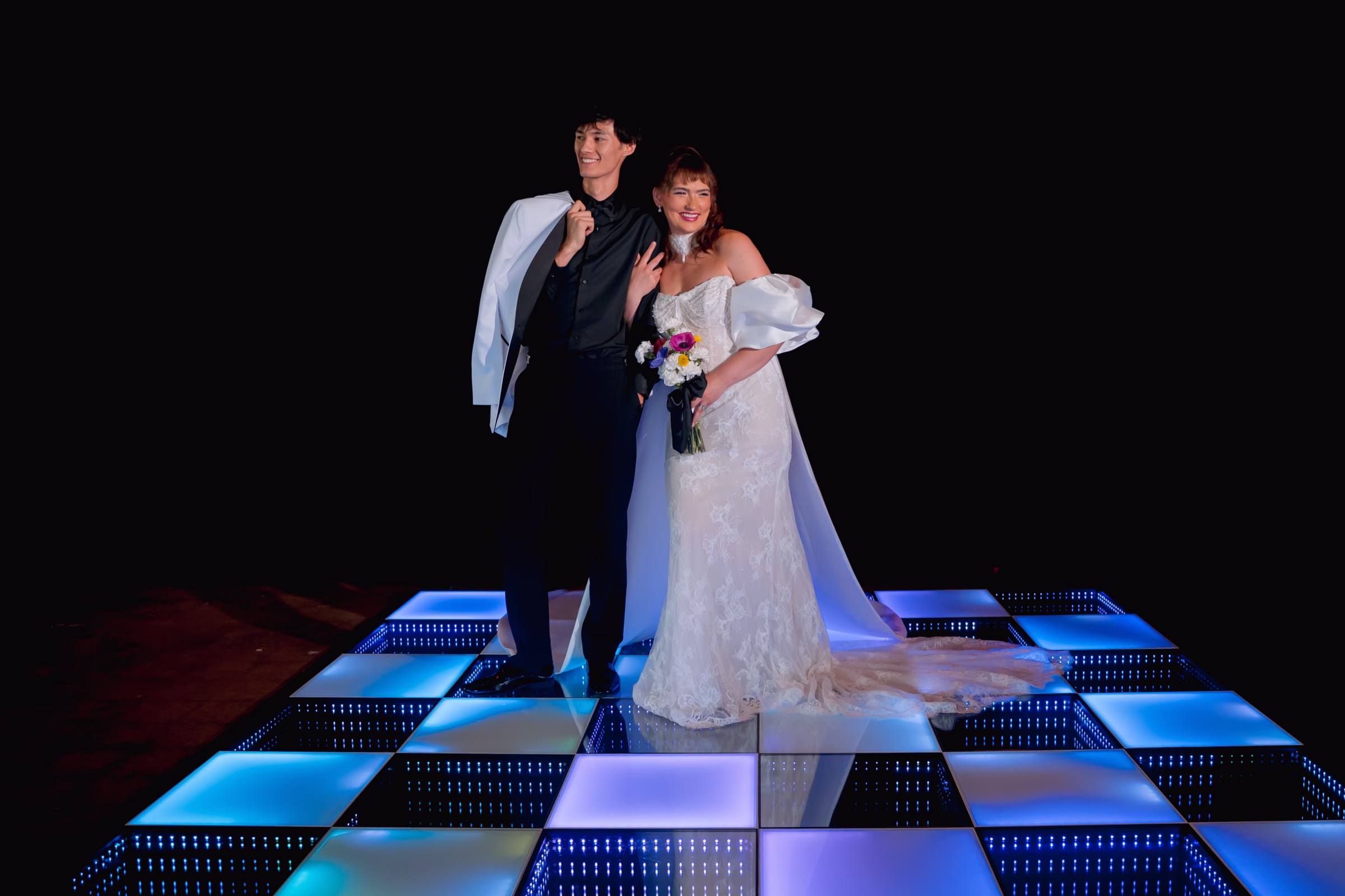 a bride and groom post on a colorful LED dance floor in Milwaukee, Wisconsin