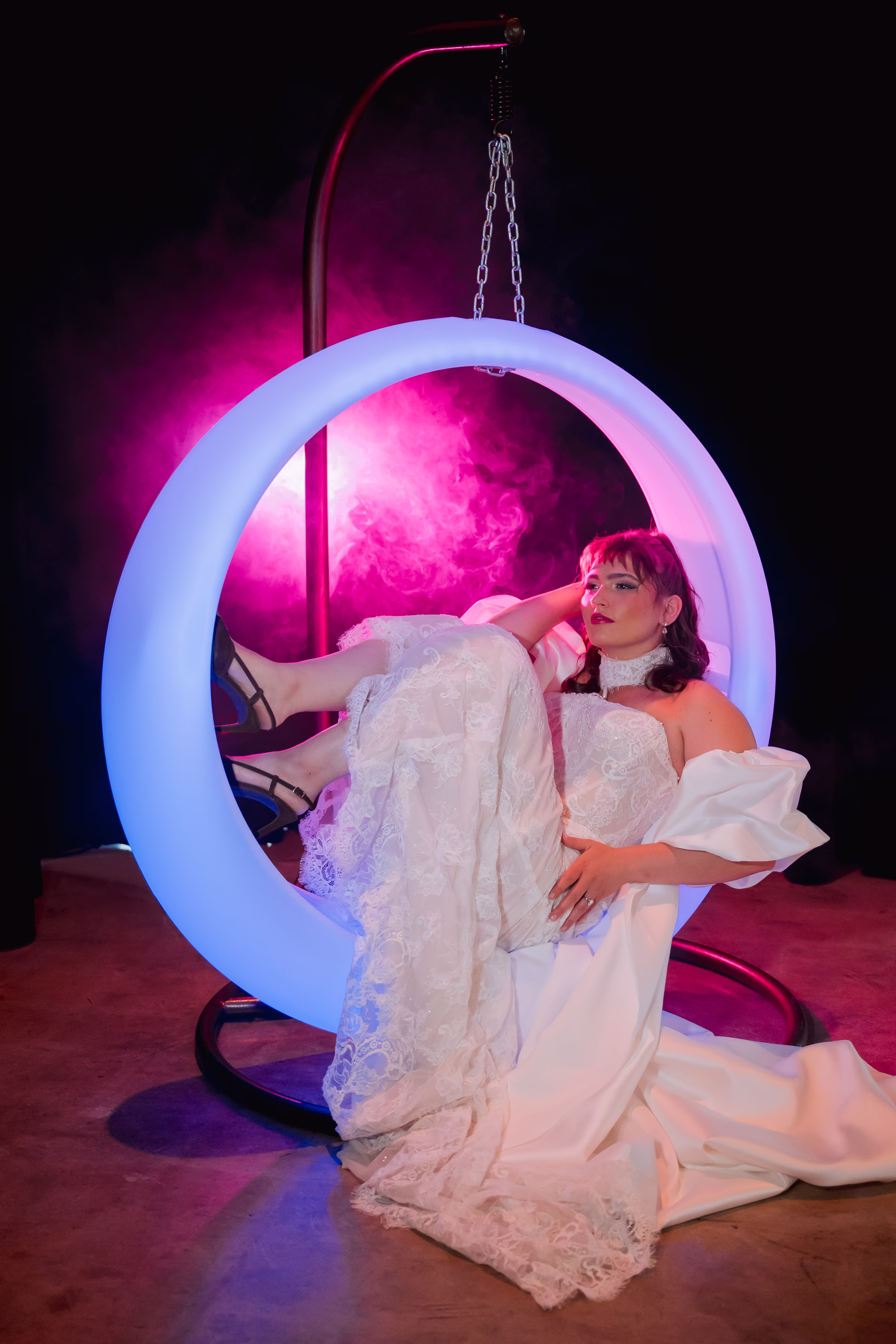 a bride lounges in an LED ring-shaped swing set from Record-A-Hit Entertainment