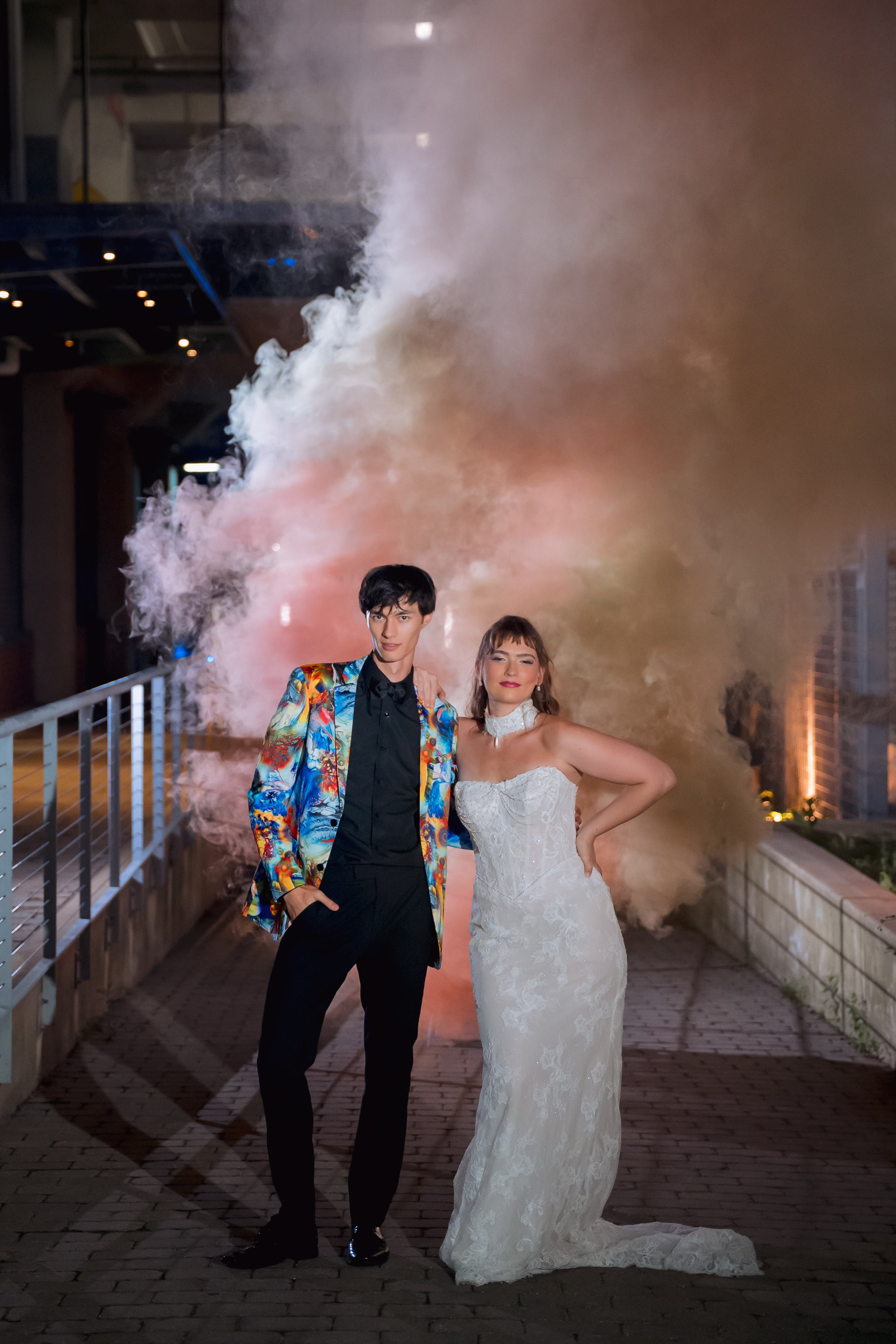 a bride and groom pose with smoke bombs behind them at Jan Serr Studio in Milwaukee, Wisconsin