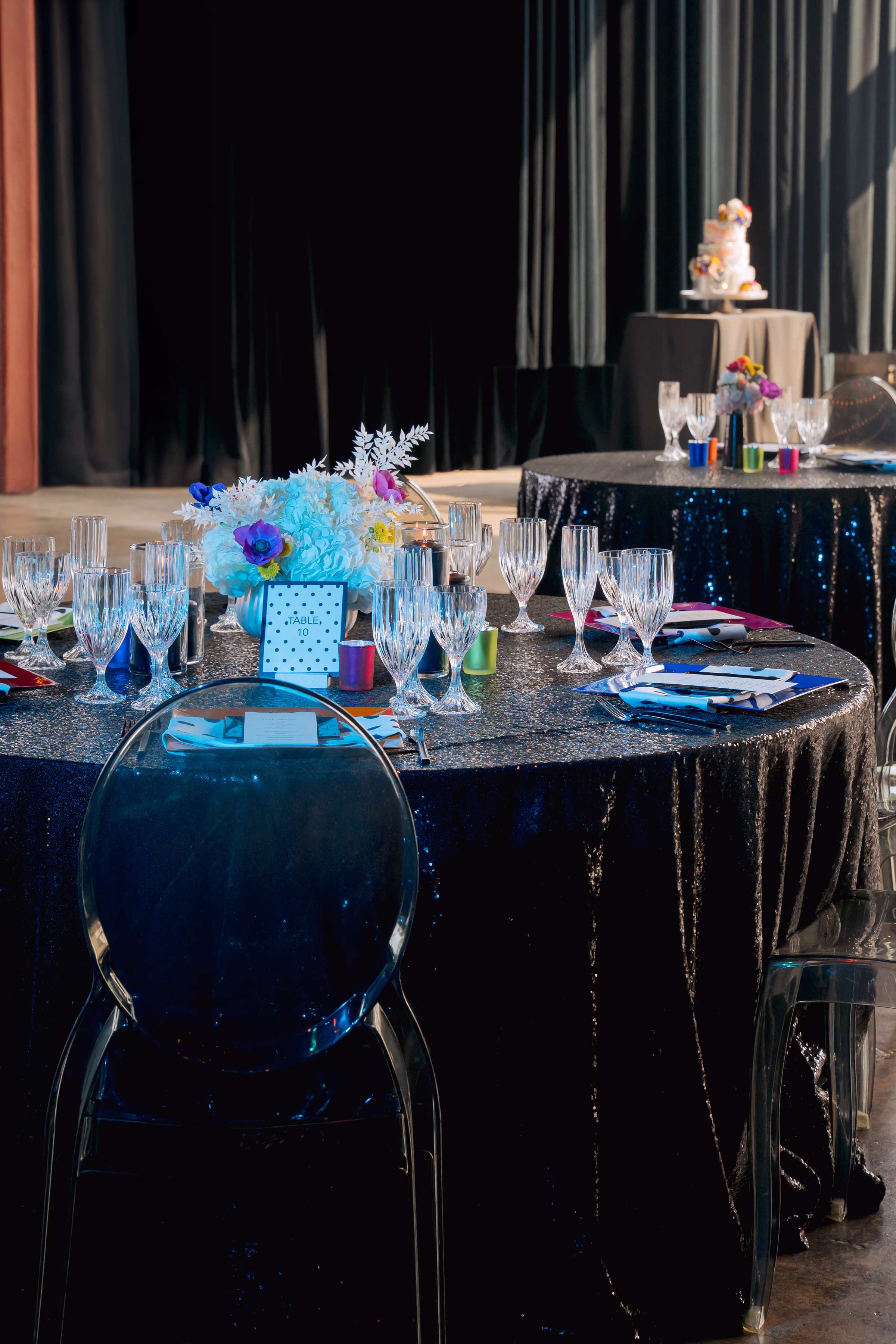 A round reception table with a black sequin tablecloth
