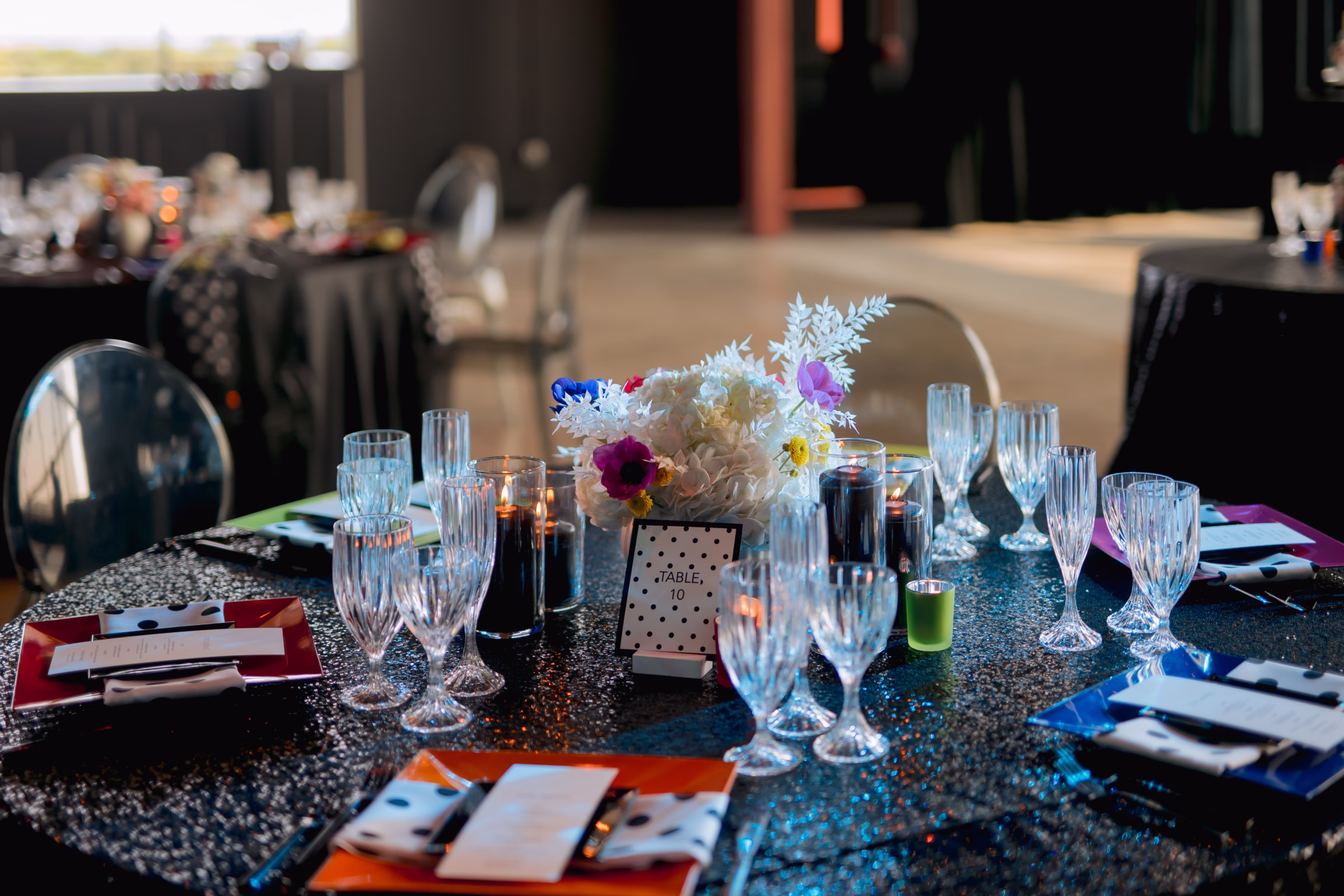 tablescape details showing table numbers and menus from Paper Envy, LLC, florals from Flowers for Dreams, glassware, plates, and details
