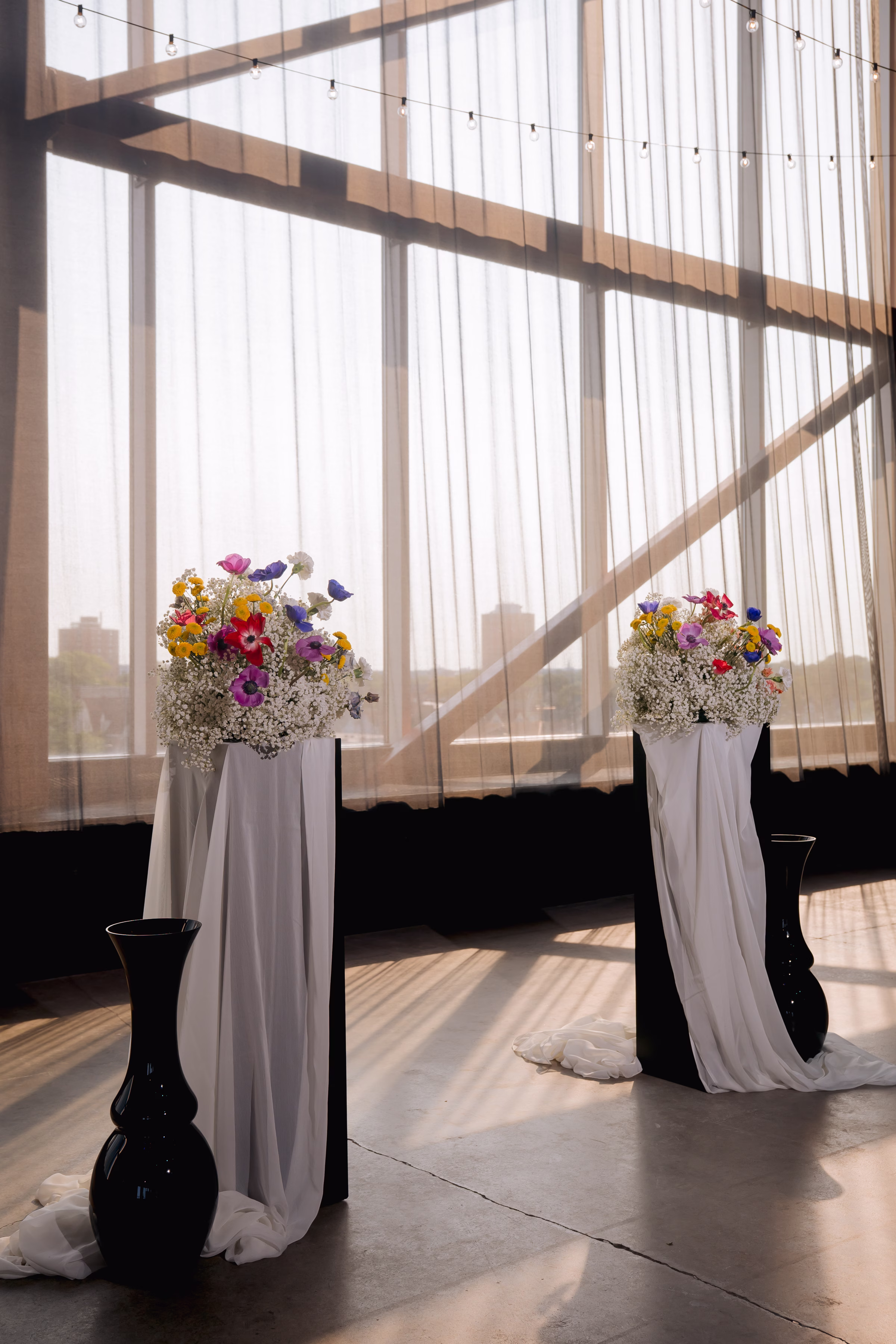 an eclectic wedding ceremony backdrop at Jan Serr Studio in Milwaukee, Wisconsin