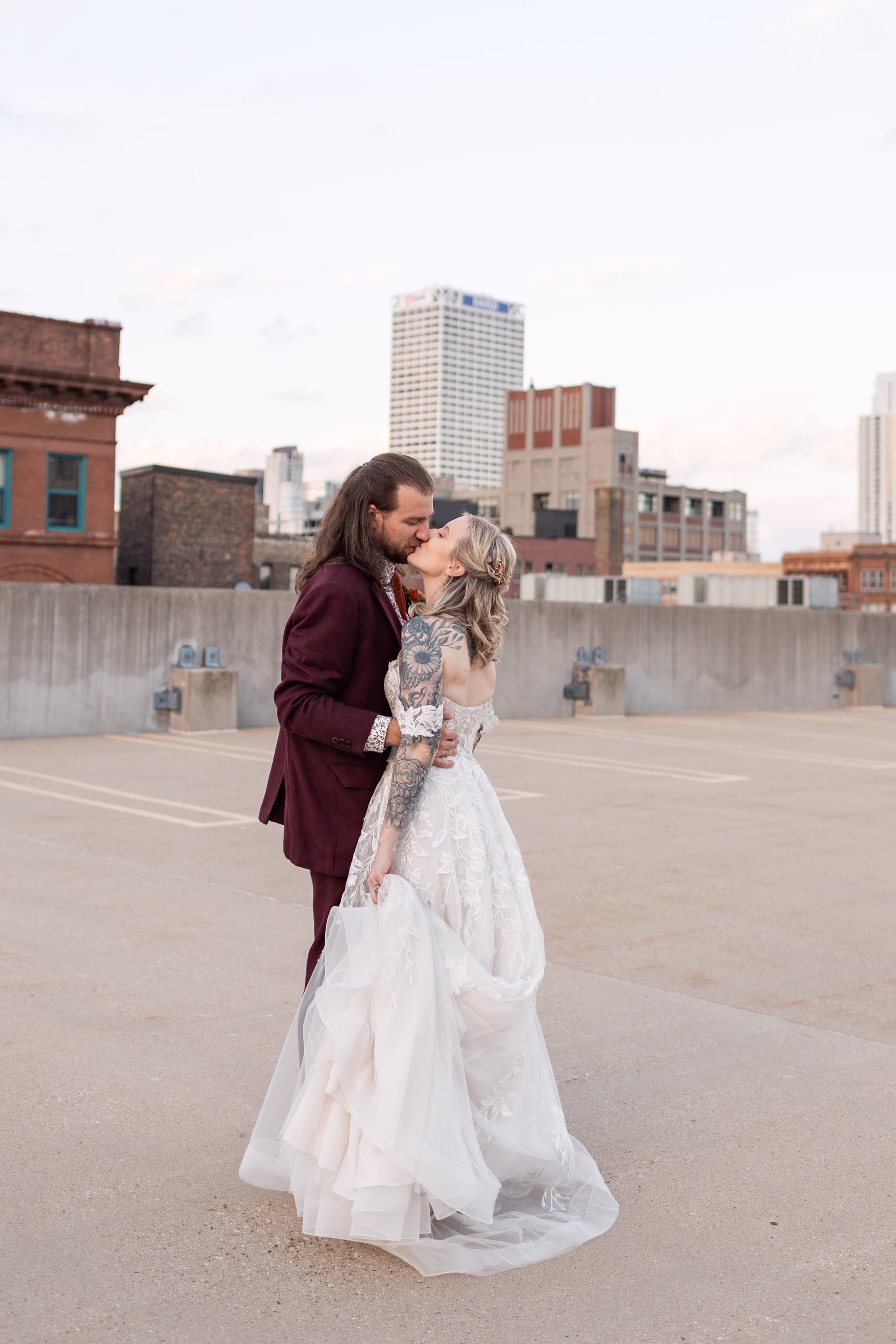 moody romantic fall wedding loft on broadway milwaukee couple portraits 622 11347 - A Moody, Romantic Fall Wedding at The Loft on Broadway | Sarah + Nathan a newlywed couple shares as kiss surrounded by urban landscapes and the Milwaukee cityscape