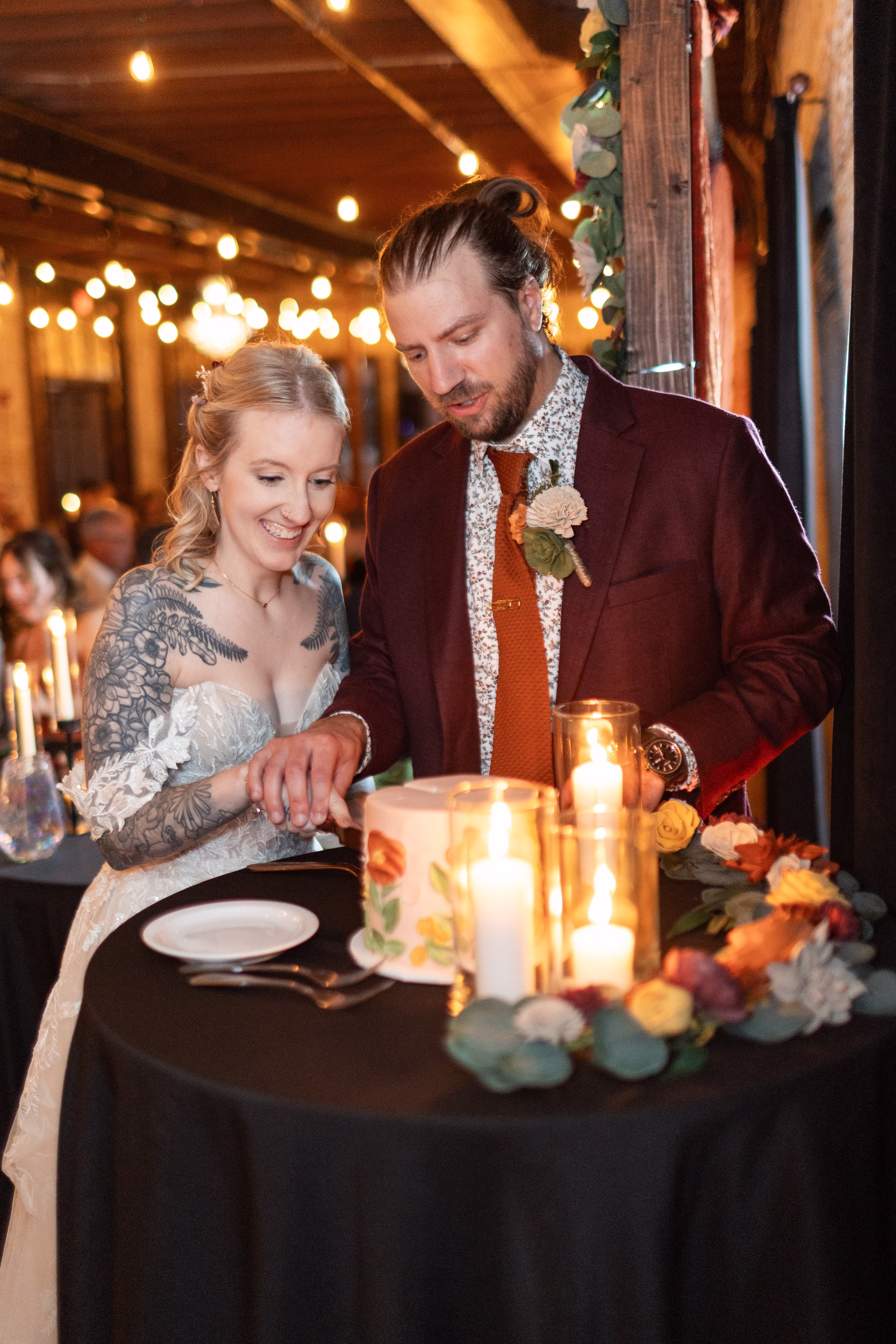 moody romantic fall wedding loft on broadway milwaukee reception cake 718 1147 - A Moody, Romantic Fall Wedding at The Loft on Broadway | Sarah + Nathan a couple cuts the cake at their Milwaukee wedding