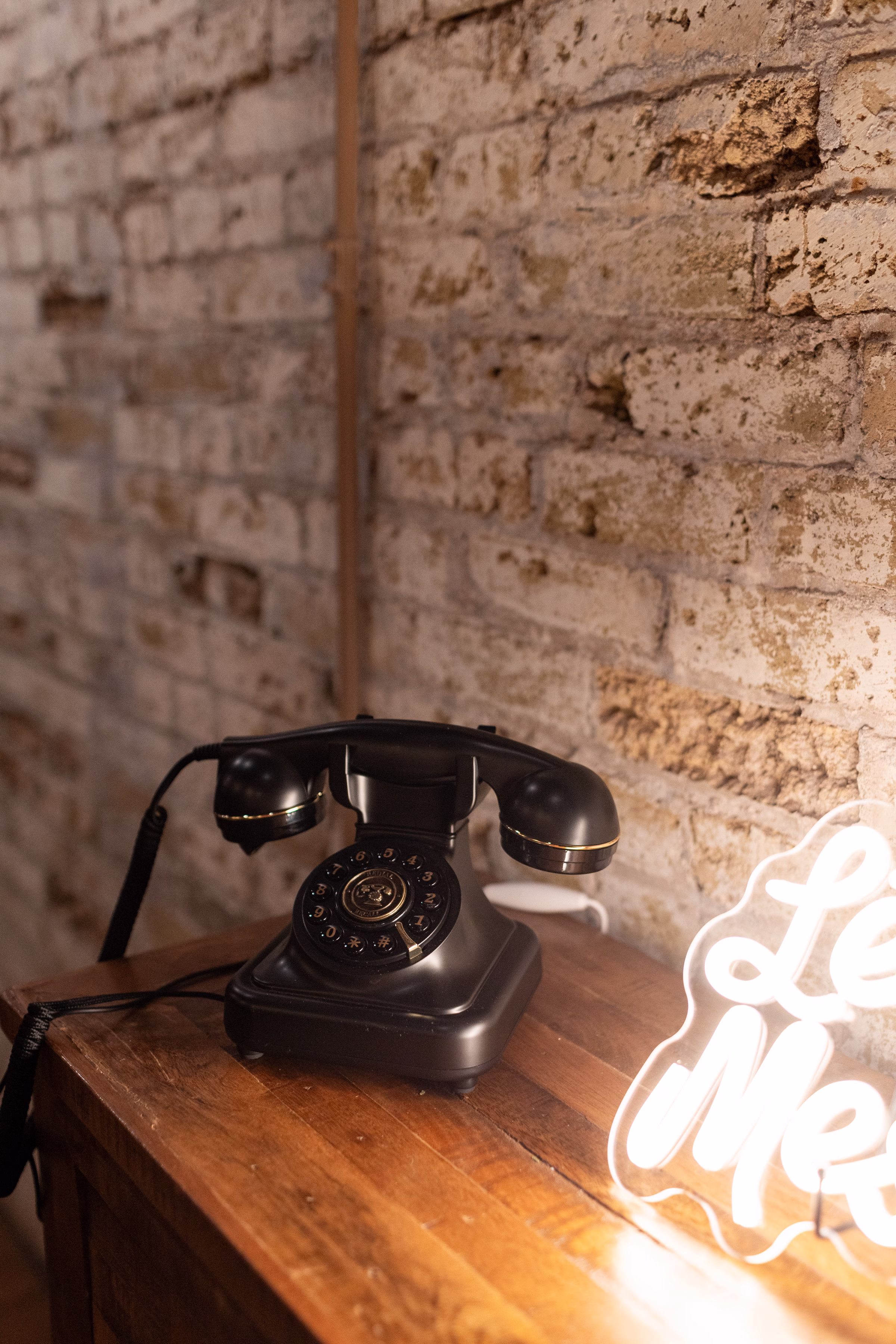moody romantic fall wedding loft on broadway milwaukee reception details 774 1279 - A Moody, Romantic Fall Wedding at The Loft on Broadway | Sarah + Nathan a detail photo showing a black vintage phone audio guestbook