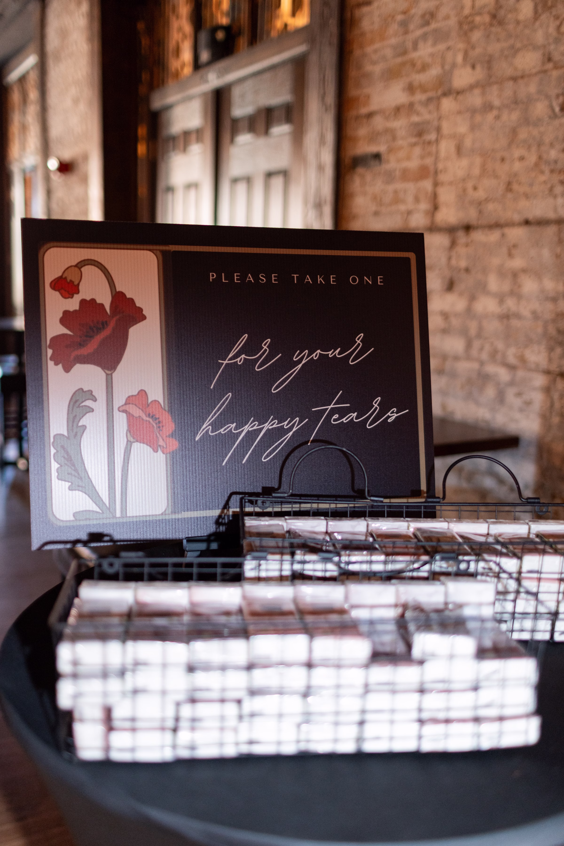 moody romantic fall wedding loft on broadway milwaukee reception signage 380 0640 - A Moody, Romantic Fall Wedding at The Loft on Broadway | Sarah + Nathan custom wedding signage that says "for your happy tears," alongside Kleenex for guests