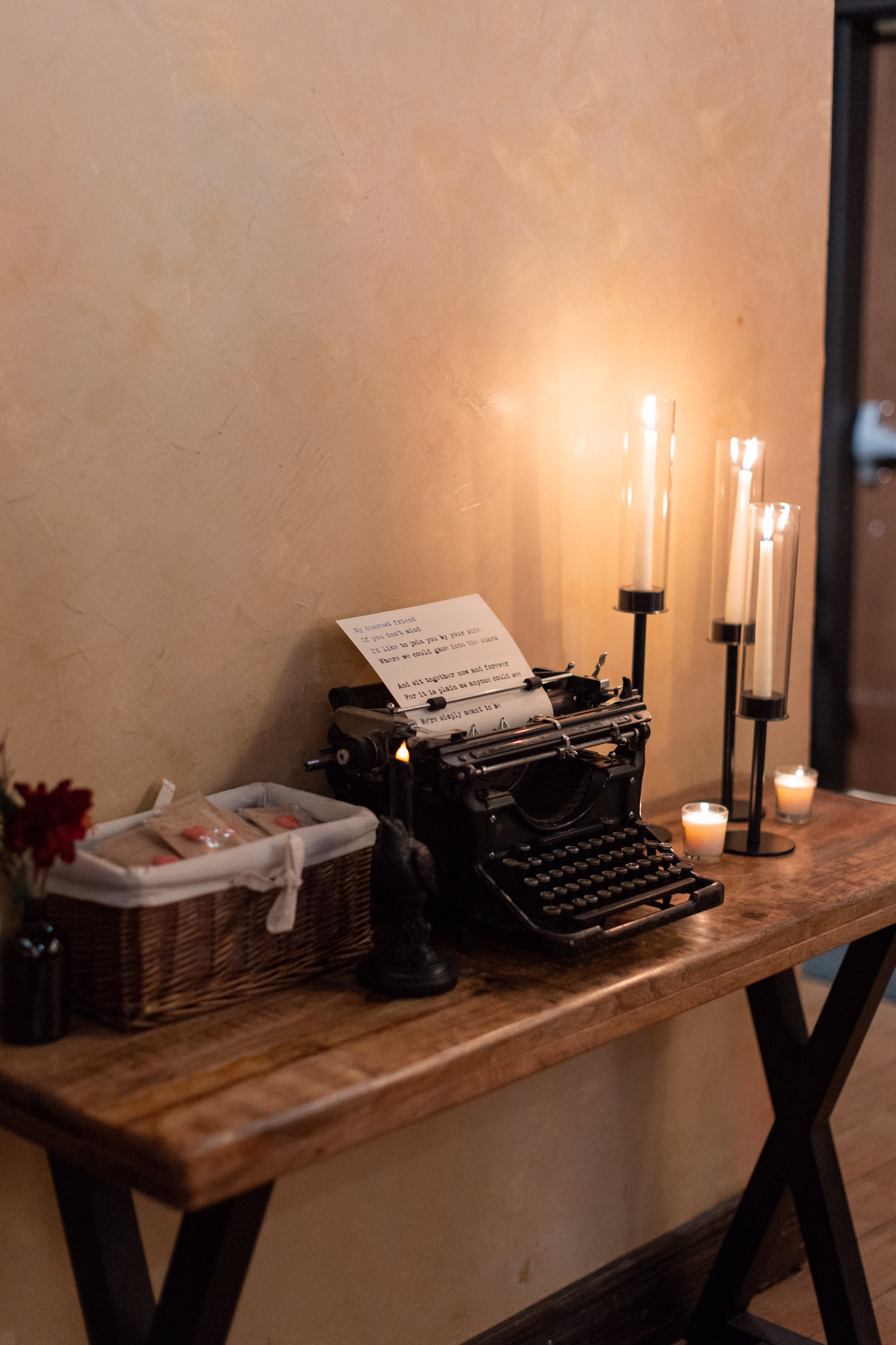 moody romantic fall wedding loft on broadway milwaukee reception signage 386 10773 - A Moody, Romantic Fall Wedding at The Loft on Broadway | Sarah + Nathan vintage typewriter wedding décor sits beside glowing candles at a moody fall wedding in Downtown Milwaukee, Wisconsin