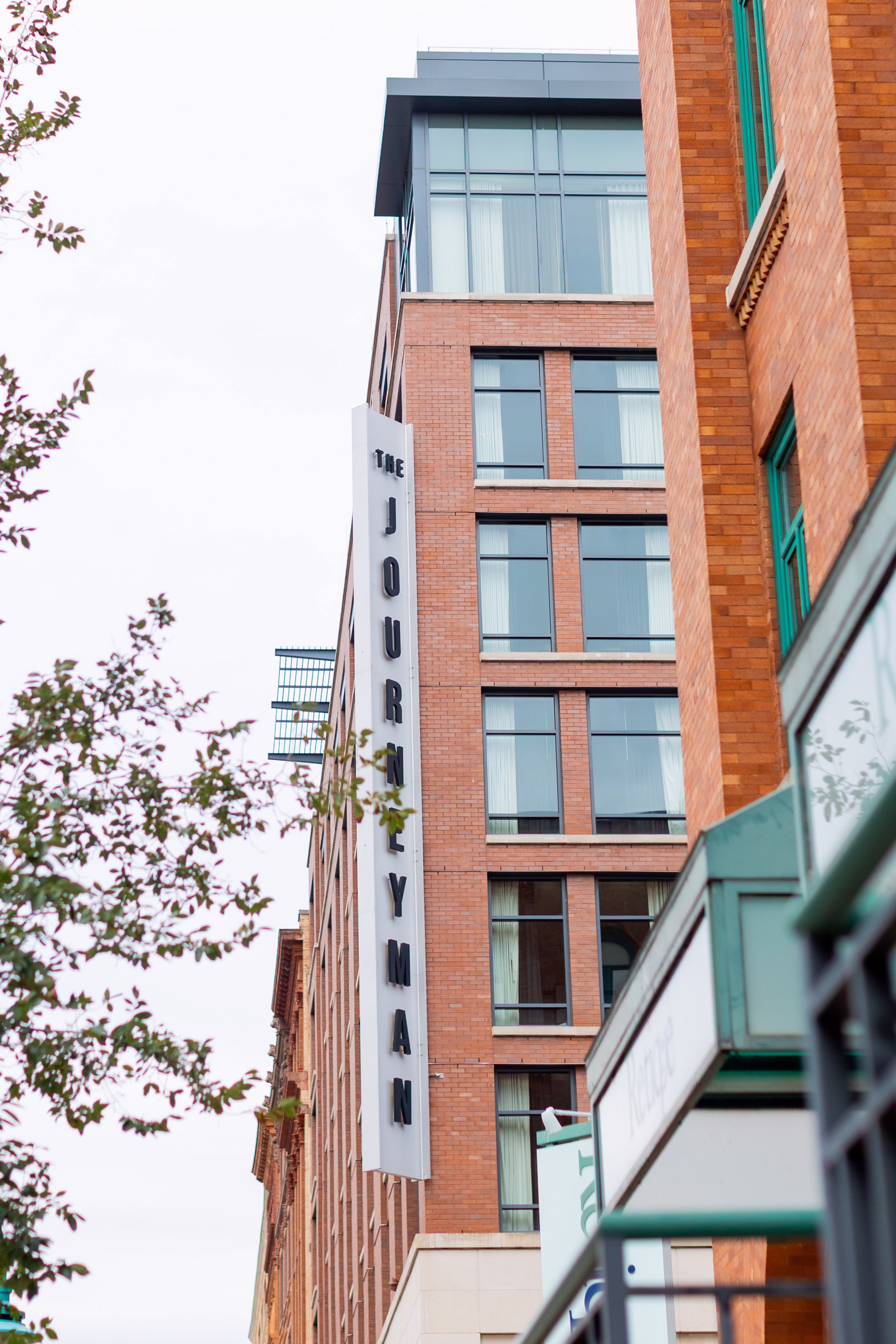 moody romantic fall wedding loft on broadway milwaukee wisconsin 38 10088 - A Moody, Romantic Fall Wedding at The Loft on Broadway | Sarah + Nathan a photo showing the outside of The Kimpton Journeyman Hotel in Milwaukee, Wisconsin