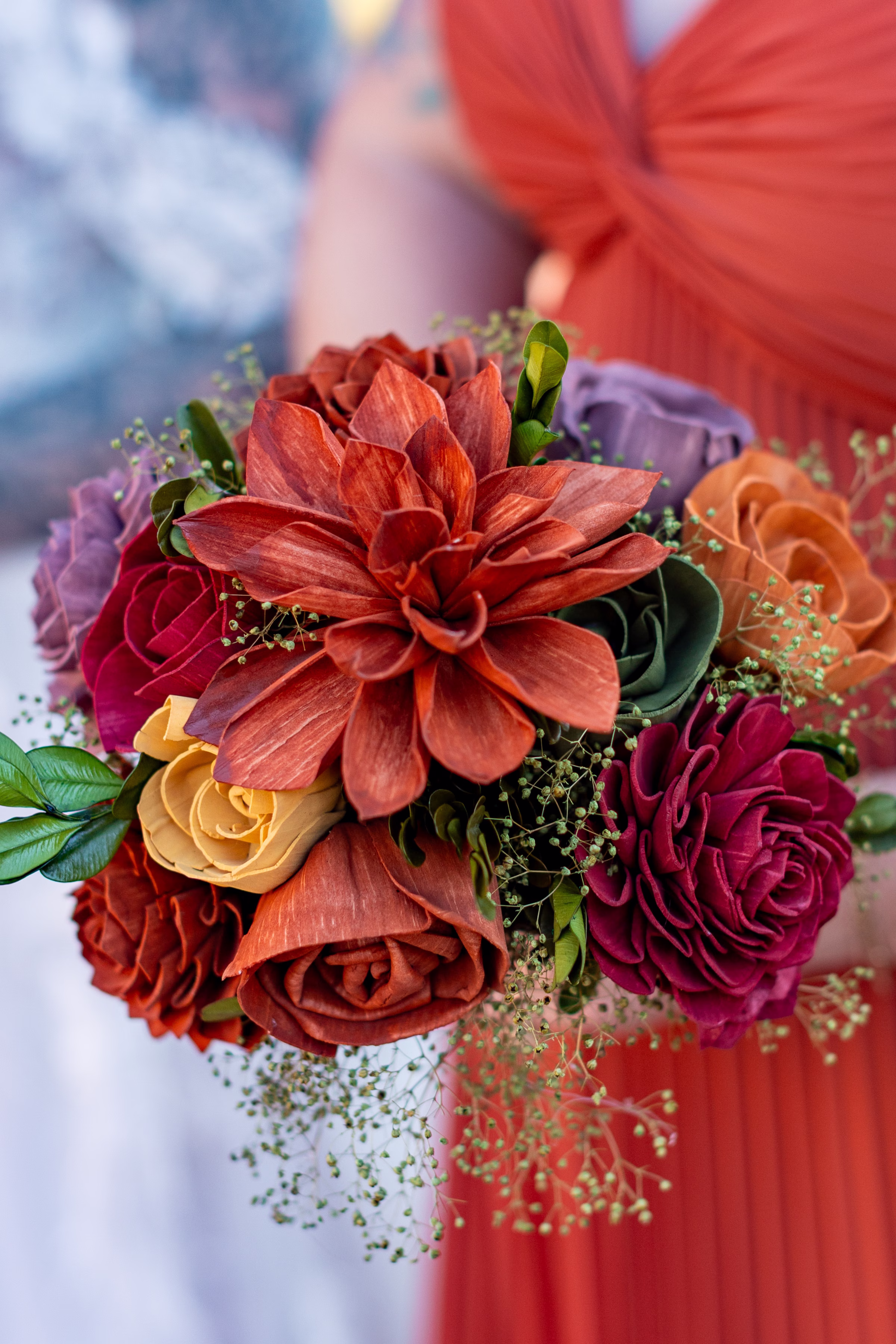 moody romantic fall wedding loft on broadway milwaukee wisconsin bridesmaids portraits 228 10445 - A Moody, Romantic Fall Wedding at The Loft on Broadway | Sarah + Nathan a close-up on a wooden flower bridesmaid bouquet in shades of red, orange, burgundy, lavender, green, and yellow