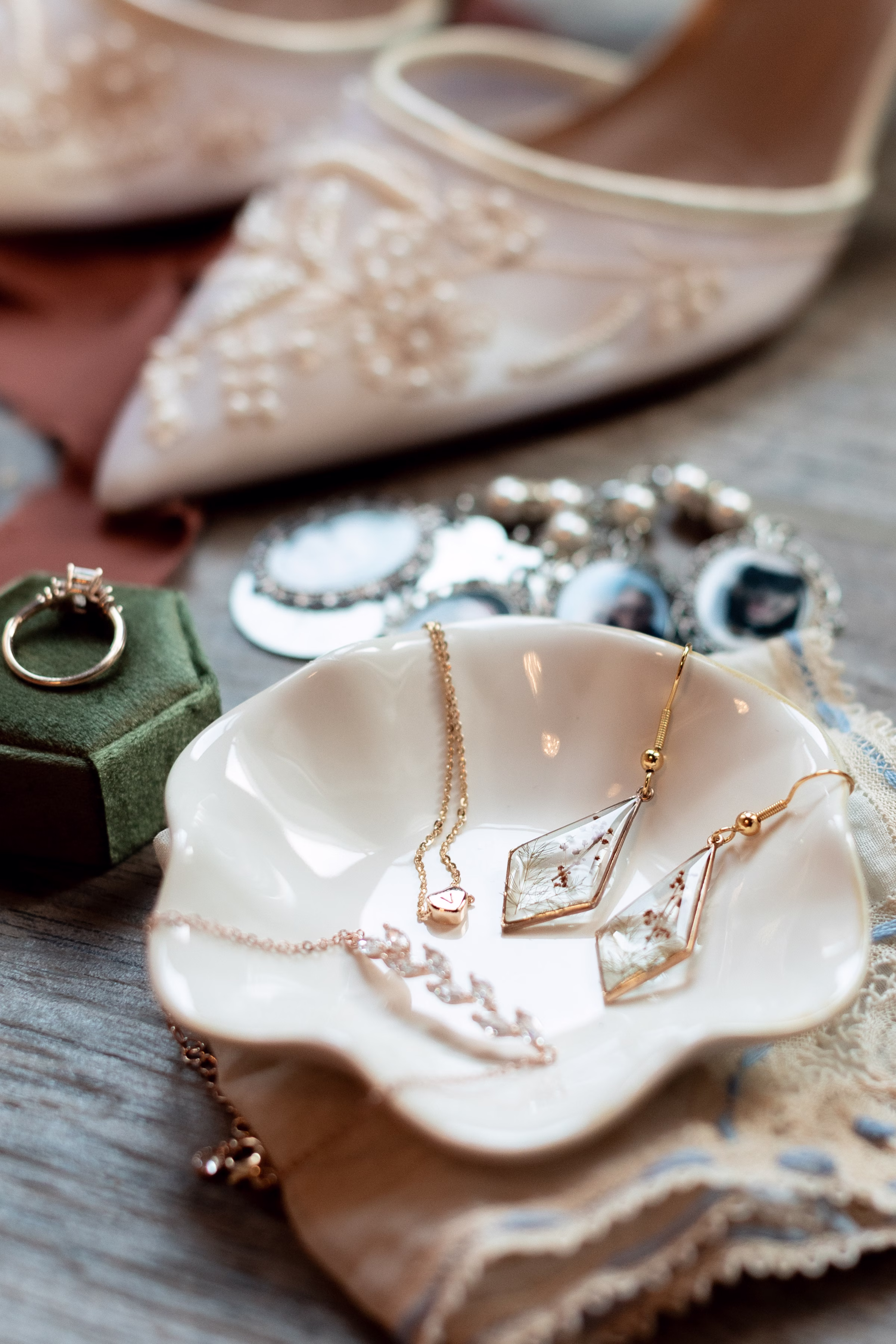 moody romantic fall wedding loft on broadway milwaukee wisconsin jewelry 21 10036 - A Moody, Romantic Fall Wedding at The Loft on Broadway | Sarah + Nathan a detail photo of bridal accessories including earrings, a necklace, bracelet, and rings