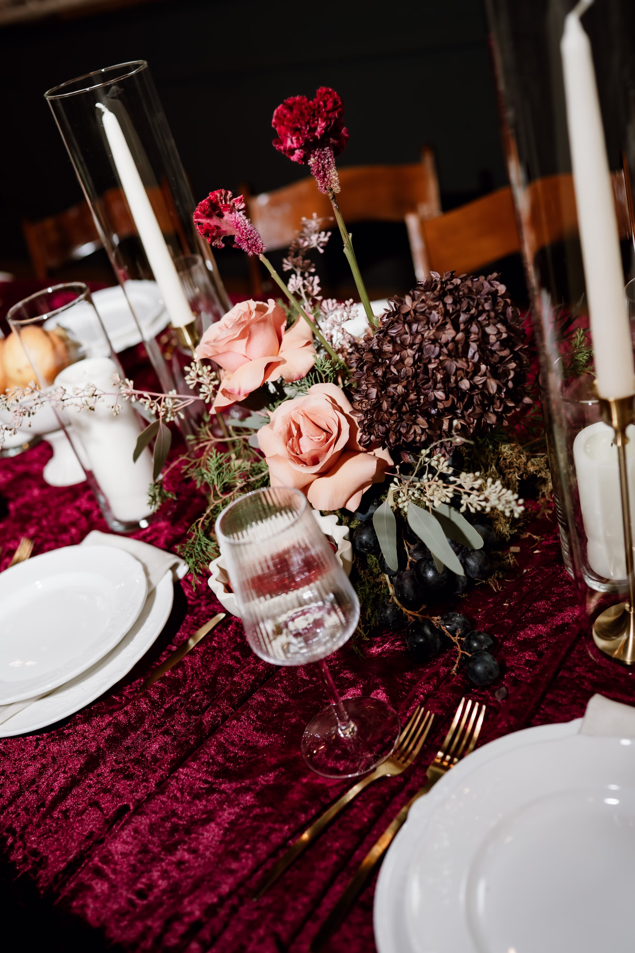 rich velvet fall wedding inspiration mercantile hall burlington wisconsin burgundy tablescape details 1 - Rich Velvet Fall Wedding Inspiration at Mercantile Hall in Burlington, Wisconsin a close-up of a floral centerpiece for a rich velvet fall wedding