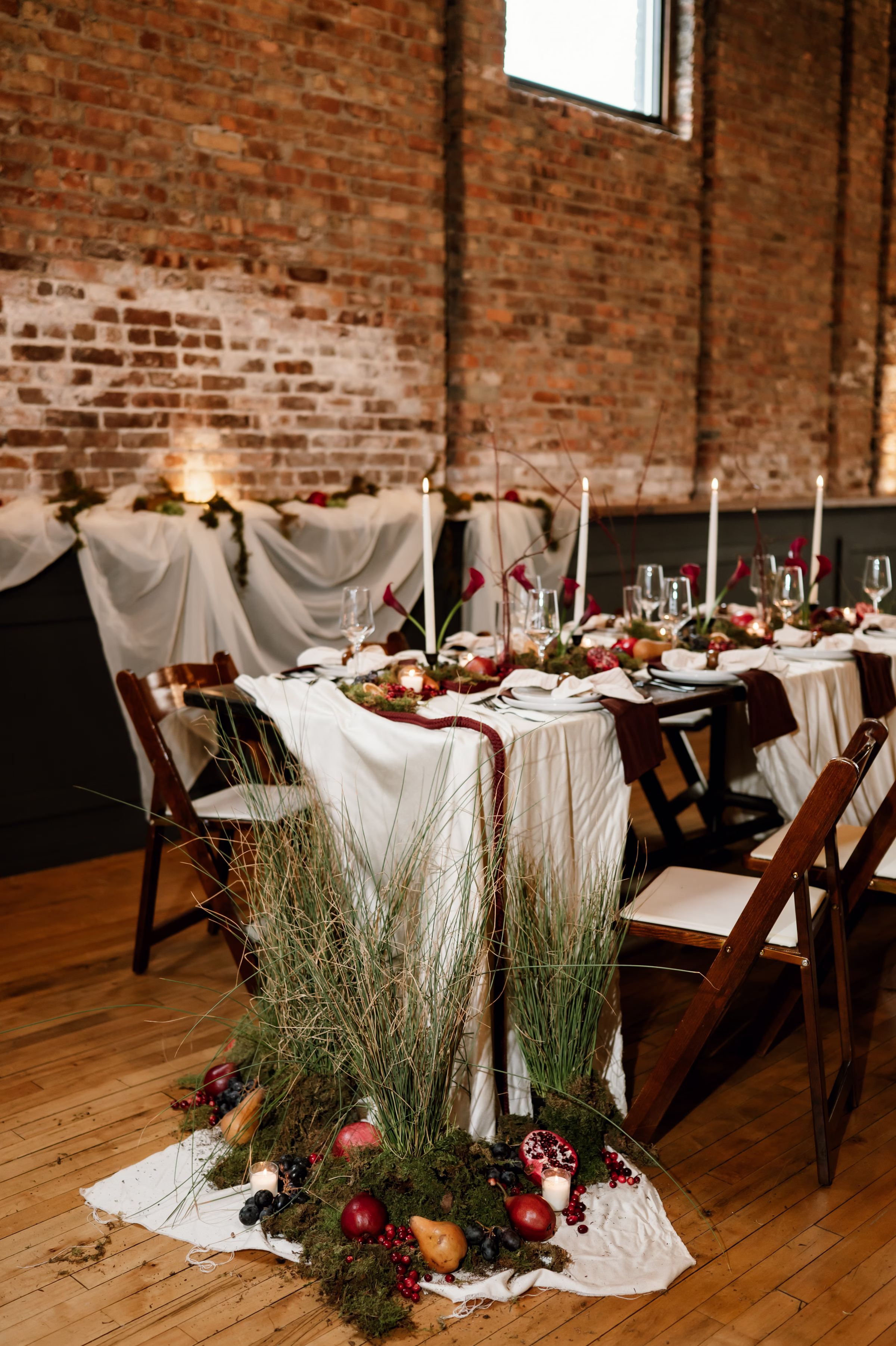 rich velvet fall wedding inspiration mercantile hall burlington wisconsin tablescape decor florals 18 - Rich Velvet Fall Wedding Inspiration at Mercantile Hall in Burlington, Wisconsin trendy fruit as décor and mossy grasses from The Flower Bar and Anna's Florals artfully arranged at the end of a reception table